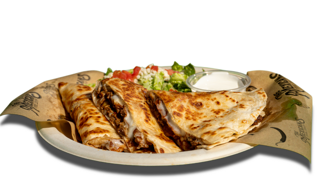 Fajita quesadilla from The Mexicans Food Truck in Dallas, made with seasoned beef, melted cheese, and served with sour cream and fresh salad.